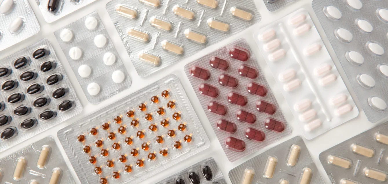 colorful-pills-in-blister-packs-on-table