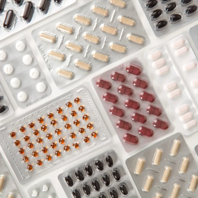 colorful-pills-in-blister-packs-on-table